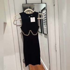 Black mini dress with gold chain accent